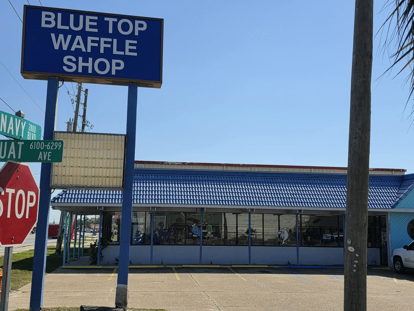 The Blue Top Waffle Shop sign and blue-roofed diner on Navy Boulevard